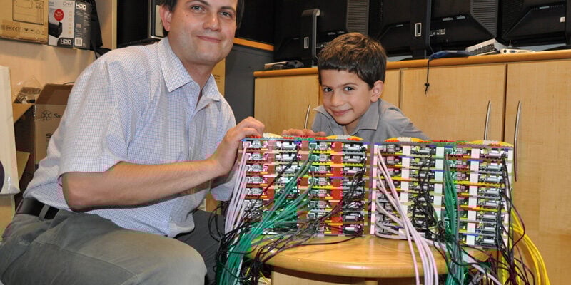 Prof Cox, James, and a lot of Raspberry Pis