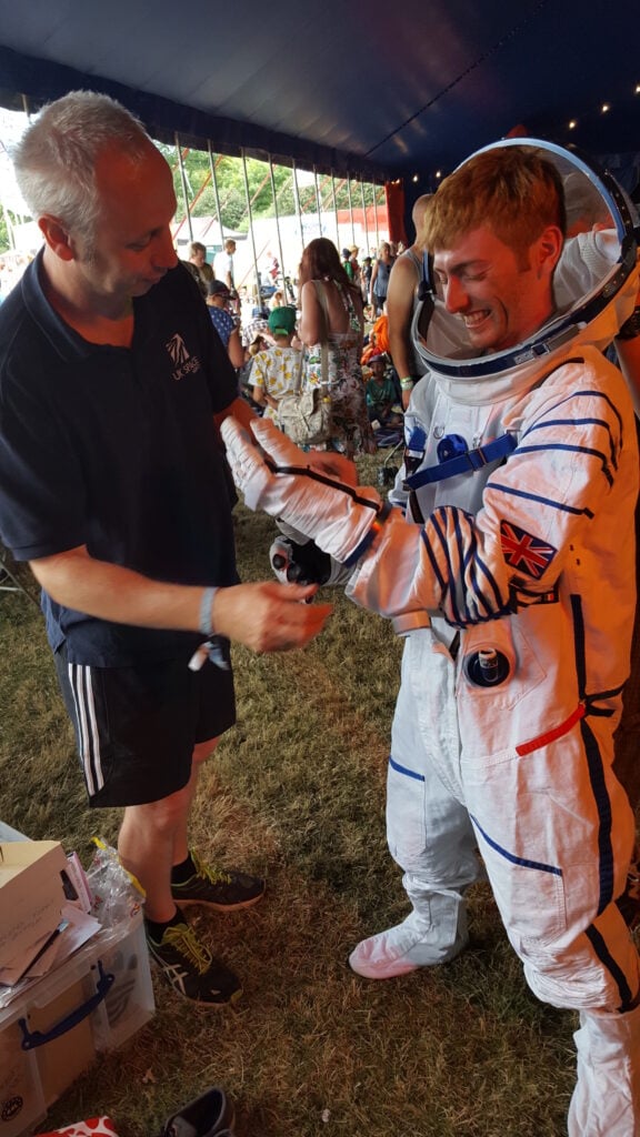Tony from UK Space helps Raspberry Pi's Dan Grammatica don a spacesuit