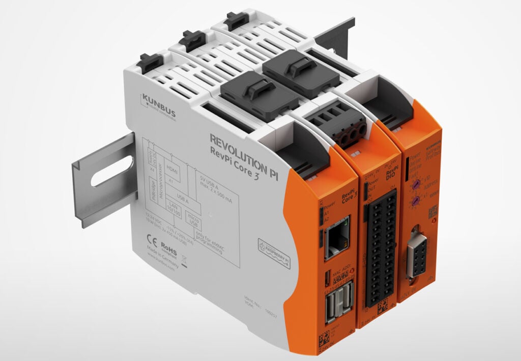 This image showcases an industrial electronic module, possibly a programmable logic controller (PLC) or a similar automation device, given its structured and modular design. The device is labeled "KUNBUS" and is part of the "REVOLUTION Pi" series, model "RevPi Core 3+". The gray and orange color scheme indicates it's a piece of professional equipment. Visible on the module are several ports and interfaces: it has standard communication interfaces such as Ethernet ports, and a series of connectors for peripheral devices or for expansion modules. The connectors are well-organized, and the device appears to be designed for easy installation onto a DIN rail, as evidenced by the metal mounting clip on the side. Safety and regulatory compliance marks like "CE" and "RoHS" are visible, indicating adherence to European safety and environmental standards.