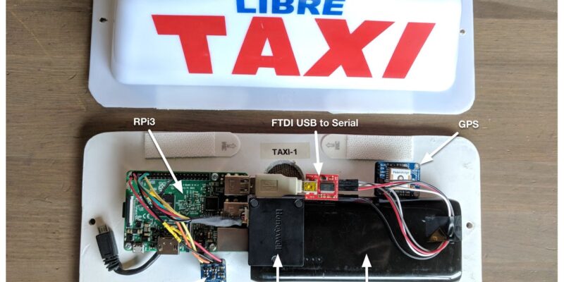 A taxi sign next to electronic devices to measure air quality