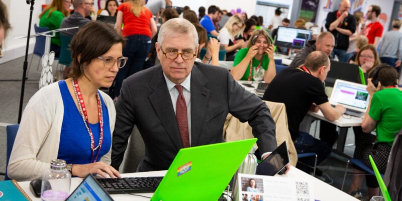 Prince Andrew and a woman watching a computer screen