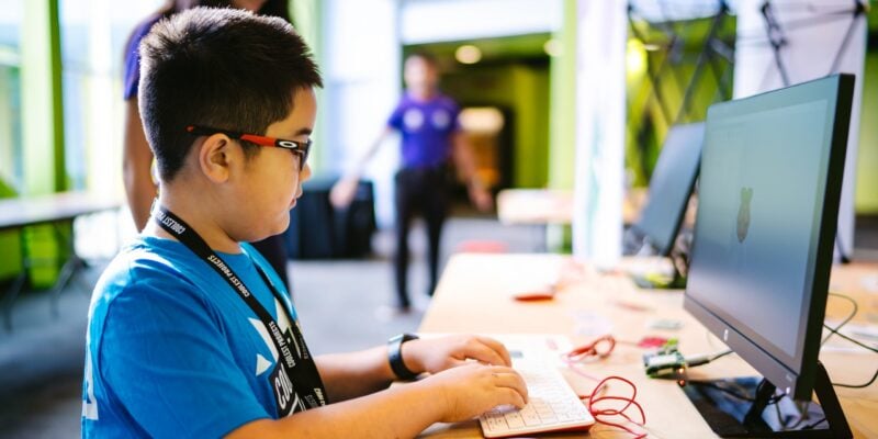 A boy using a Raspberry Pi desktop computer