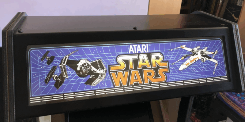 header of the arcade cabinet bearing a Star Wars logo