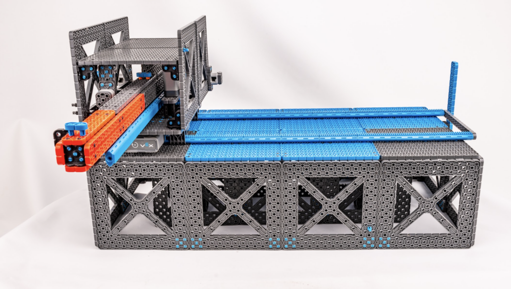 As the arm is over a seedling, the VEX IQ microcontroller pushes a button that is sensed by Raspberry Pi and triggers a watering pump to stream water over the plant