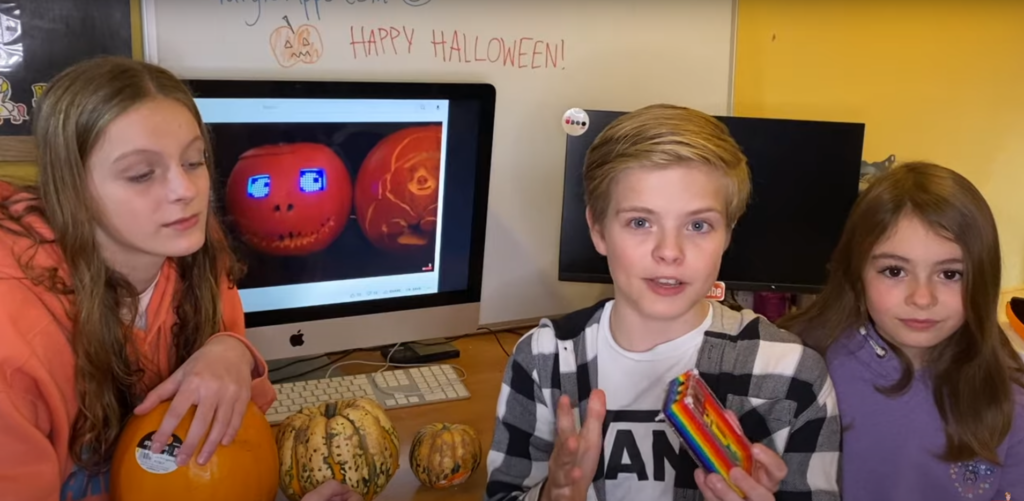 Team Gurgle Apps posing with their pumpkins and a computer in the background