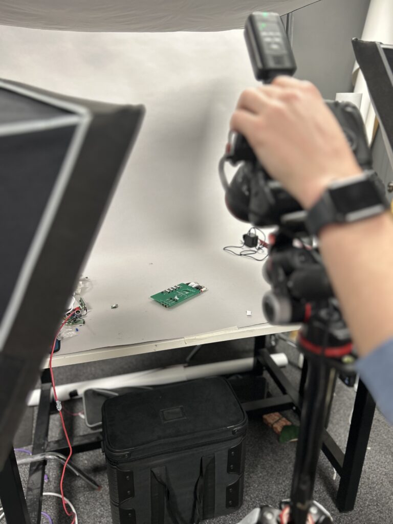 our pi 5 on our photographer's set with a camera above it being operated by a hand