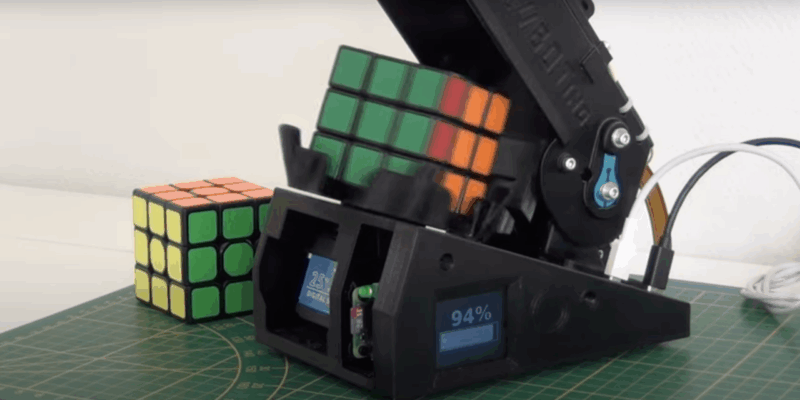 close up of cube solving robot showing the display screen with a corner of the raspberry pi visible in a slot behind it