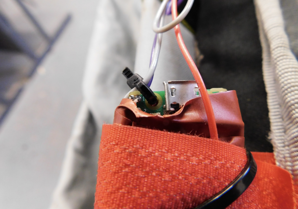 a different view of the wrapped up pico inside the orangey red tape