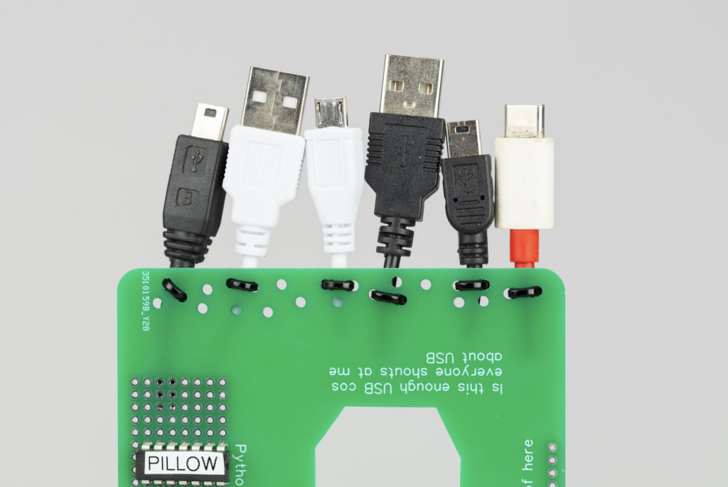 a close up of all the usb usb c lightning connectors poking out the top end of the green PCB board