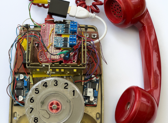 The image shows a disassembled vintage rotary telephone. The internal components, including the wiring and circuitry, are exposed, and the red receiver is disconnected. The telephone features: A beige base with visible signs of wear and aging. A clear plastic rotary dial with numbers from 1 to 0 arranged in a circle. Two golden bells visible beneath the rotary dial. Various colorful wires and electronic components like resistors, capacitors, and a circuit board exposed above the dial. A red coiled cord connected to a modern USB adapter that seems out of place with the vintage design of the telephone. The red receiver is detached and lies beside the phone base; it has a classic design typical for older telephones. OCR Text: “DIAL 999 FOR FIRE POLICE AMBULANCE\nLeamington Spa 30599” !Rotary Dial Telephone This vintage phone evokes nostalgia and a sense of simpler times when rotary dials were the norm. The Leamington Spa number adds a touch of locality and history