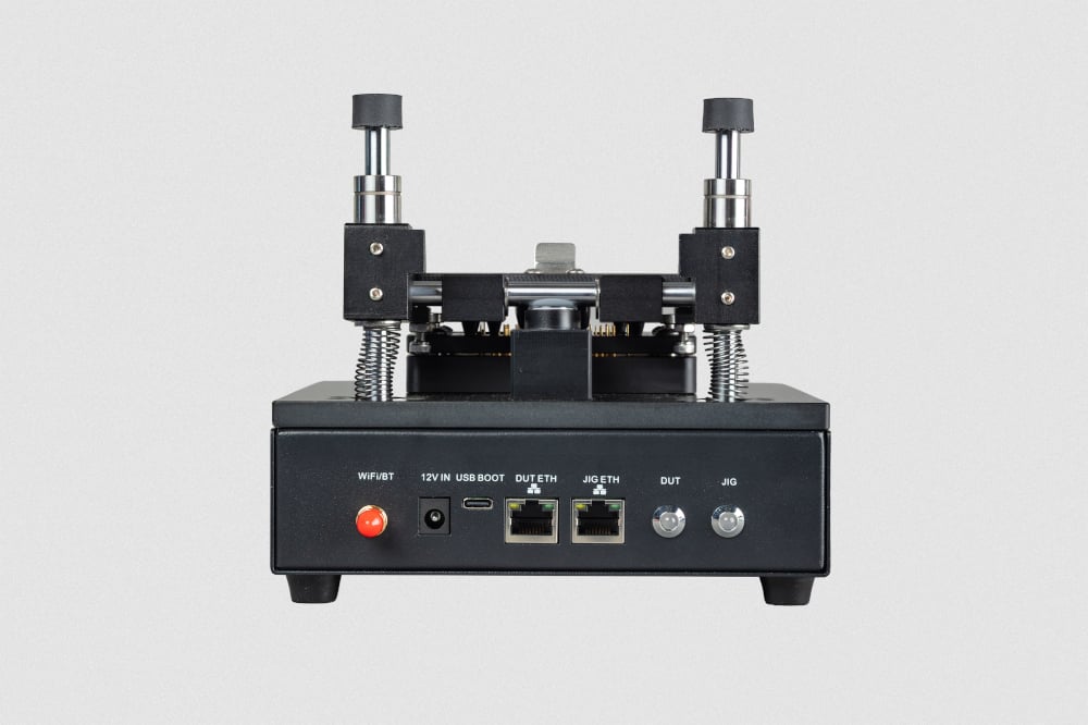 The Wi-Fi antenna connector, LEDs for the DUT and JIG, and the following input ports: 12 V power supply, USB-C, DUT Ethernet, and JIG Ethernet.