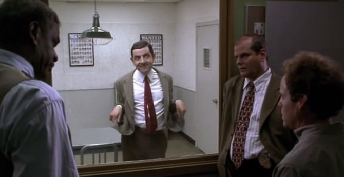 Mr Bean under police interrogation behind a two-way mirror